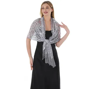 Detailed view of grey evening shawl with silver sequins and elegant tassel fringe