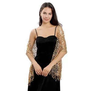 Close-up of golden sequined embroidery and fringe detail on elegant evening shawl