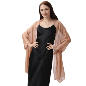 Close-up of elegant champagne gold evening shawl scarf on model with black dress