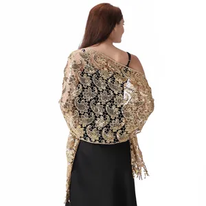 Back view of a gold sequin paisley lace shawl with fringe for evening dresses