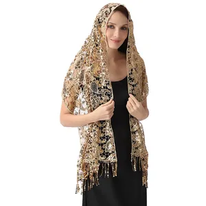 Close-up detail of golden sequin paisley lace shawl with tassels for evening wear