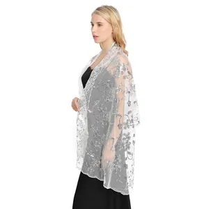 Side view of elegant white lace shawl with silver sequins for wedding evening dress