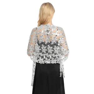 Detailed view of silver sequined lace shawl with floral pattern and tassels for evening wear