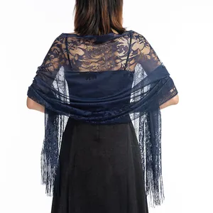 Close-up of elegant navy blue lace shawl with fringe on back of black dress.
