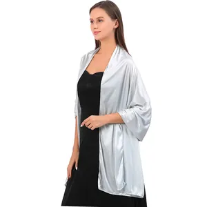 Elegant silver satin evening shawl wrap for women, styled over a black party dress