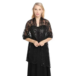 Elegant black sequin lace shawl wrap styled over an evening gown for formal wear.
