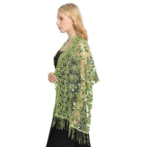 Detailed view of a green floral sequin shawl with elegant tassel hem for evening wear.