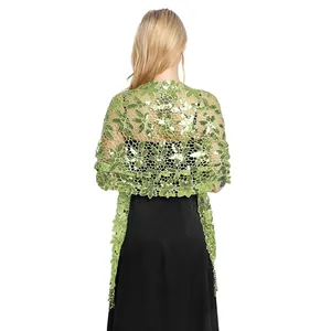 Back view of green water-soluble lace shawl with sequins and fringe details