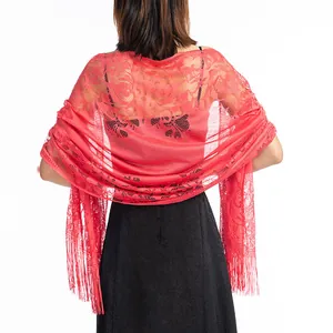 Back view of an elegant red floral lace shawl with long tassels paired with a black evening dress