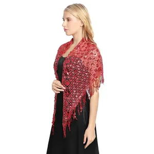 Red lace shawl with sequins and fringe detail worn by a model in a black dress