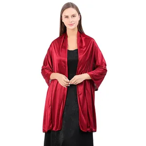 Detail view of smooth wine red satin fabric on an elegant evening shawl wrap for women