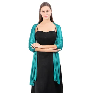Elegant teal satin evening shawl wrapped over a black party dress