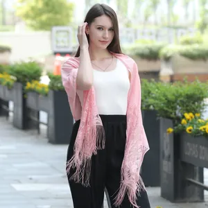 Detailed view of an elegant pink floral lace shawl featuring delicate fringe tassels