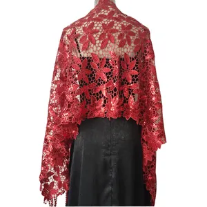 Detail of red sequined lace shawl with floral embroidery and elegant fringe tassels