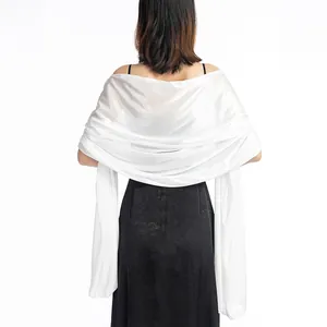 Detailed back view of elegant white silky shawl for bridal gown or evening party