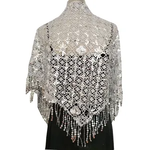 Close-up of silver sequin fringe shawl with intricate floral lace pattern for evening wear.