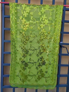 Detailed view of lime green sequin shawl with elegant floral mesh patterns