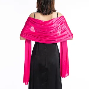Elegant magenta evening shawl wrap shown draped over the back of a black party dress