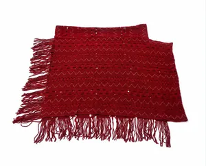 Bohemian dark red knitted poncho with decorative fringe and hollow-out wavy pattern.