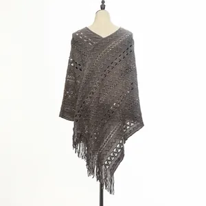 Back view of a chic grey knitted pullover poncho featuring delicate tassel fringe details
