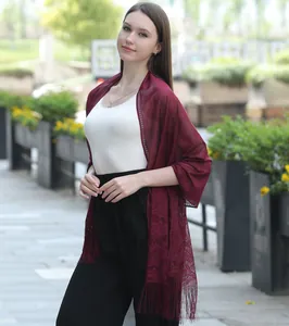 Elegant burgundy lace shawl wrap for bridesmaid or evening dress, shown on a model outdoors