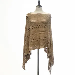 Detailed view of khaki knitted hollow-out loose poncho featuring elegant fringe tassels