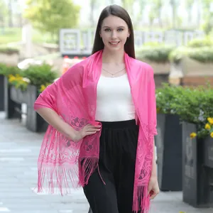 Elegant hot pink floral lace shawl scarf with delicate fringe tassels worn by model