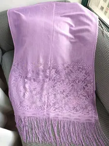 Detailed view of sweet lavender lace shawl with floral patterns and delicate long fringe