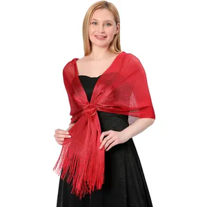 Detailed view of red metallic thread shawl with fringe and circular buckle fastener