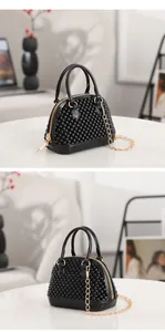 Detailed view of mini black studded jelly shell bag with stylish golden chain strap and handles