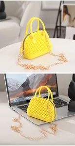 Detailed view of yellow mini jelly shell bag with textured beads and gold chain strap