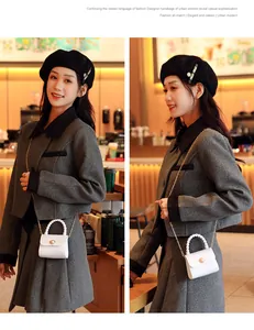 White mini pearl jelly bag with gold chain strap shown on a stylish model in a cafe setting