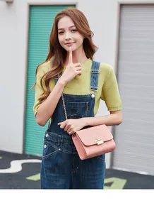 Fashionable pink quilted crossbody bag featuring a gold chain strap and metal lock