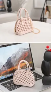 Close-up view of a pink jelly shell bag featuring a unique bubble texture placed on a laptop