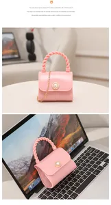 Close-up detail of a pink mini jelly handbag with a pearl lock button and gold chain