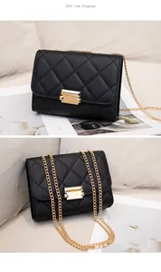 Detail showing the elegant quilted texture and gold chain of this black crossbody bag