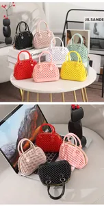 Multi-color mini jelly shell bags shown in lifestyle settings on a table and laptop.