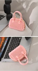 Detailed view of mini pink jelly shell handbag with beaded texture and gold zipper