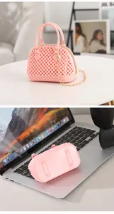 Detailed views of a pink jelly shell handbag and its bottom layout on a laptop.