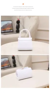 Detailed views of a mini white jelly handbag featuring crocodile texture and twisted handle