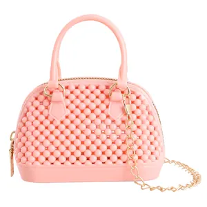 Mini pink jelly shell bag with hollow bead design and detachable gold chain strap
