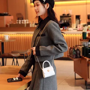 White mini croc-pattern handbag with elegant pearl handle and gold chain strap for women