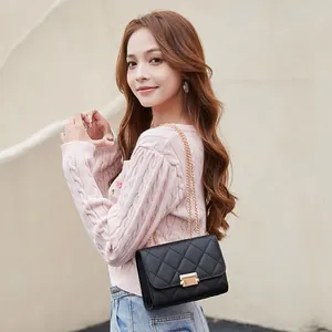 Fashionable black quilted chain crossbody bag for women featuring a stylish gold-tone lock detail
