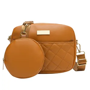 Elegant brown quilted crossbody bag with a detachable round coin pouch and gold hardware