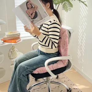 Detailed lifestyle view of a pink plush heated seat cushion on a white office chair.