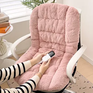 Close-up of a pink plush heated chair cushion with a wired remote control in use.