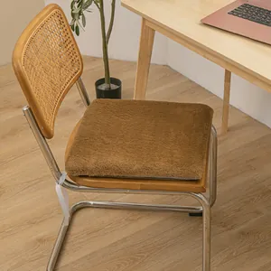 Detail of brown plush heating chair cushion on a wooden office chair in a home workspace