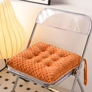 Orange minky dot textured seat cushion for office chair shown in cozy indoor detail view