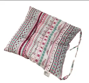 Detailed view of bohemian style thick cotton linen seat cushion with decorative ties.