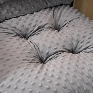 Close-up showing the soft grey minky dotted fabric texture of this thick chair cushion